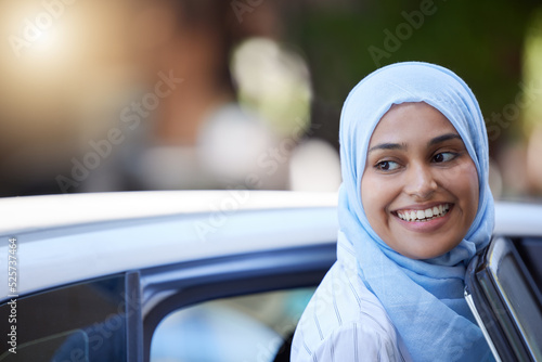 Obraz na plátně Muslim business woman using car to travel for transport in urban city, thinking of location and happy on work trip