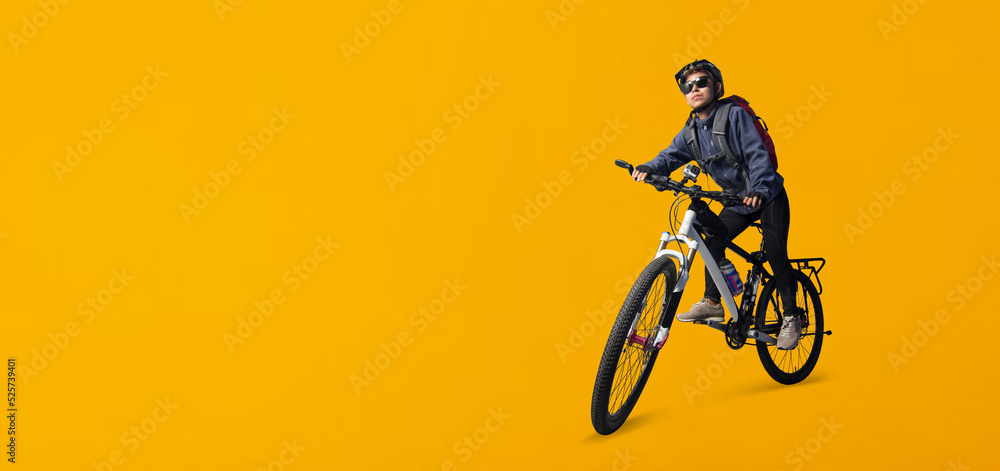 Naklejka premium Cyclist woman riding a bike isolated on yellow background, Clipping paths for design work empty free space