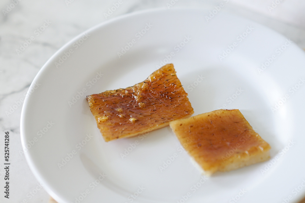 Fried pork skin on a white plate. Pig food culinary cuisine. Fried pork skin on a white plate. Pig food culinary cuisine.