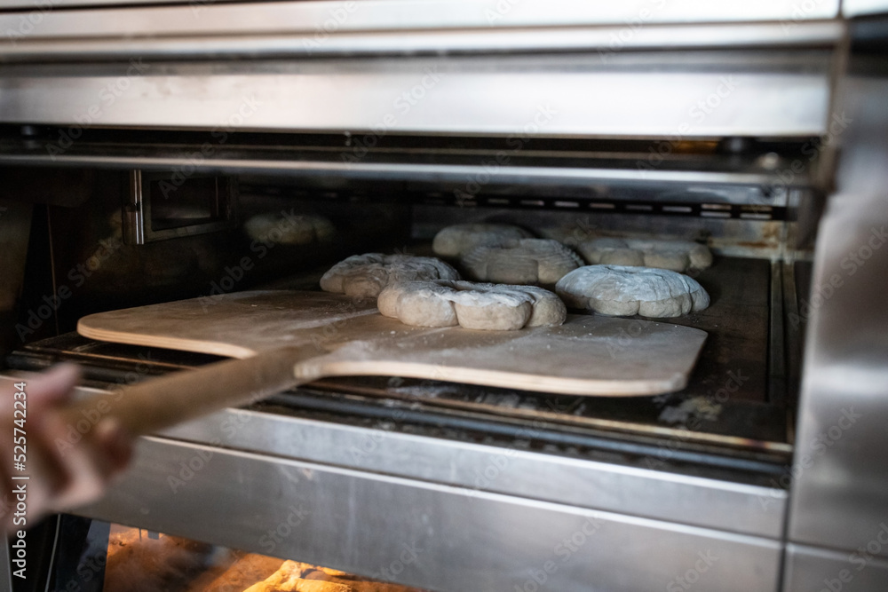 The process of making traditional French bread in an artisan bakery. Bordeaux Corona baking. Front view. The process of making traditional French bread in an artisan bakery. Bordeaux Corona baking. Front view.