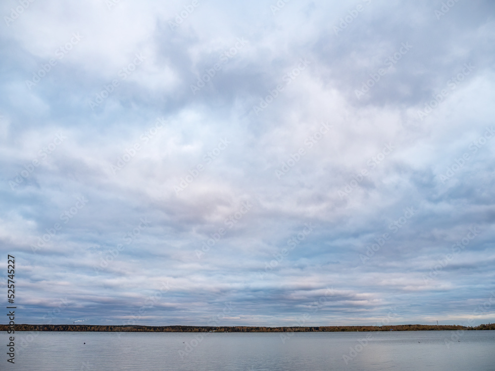 Lake with pine and birch forest on the shores at summer or early autumn sunset. Lake with pine and birch forest on the shores at summer or early autumn sunset.