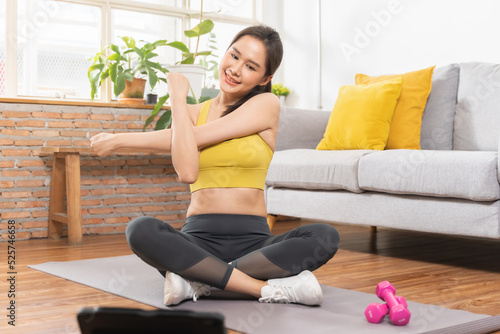 Beautiful fitness asian young woman, girl in sportswear, using tablet for online training strength muscles workout, exercise training at home for healthy body strong athletic fit, active lifestyle.