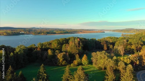 Drone shot of Hudson valley river in upstate new york with green trees and forest in a sunset 4K UHD 3840