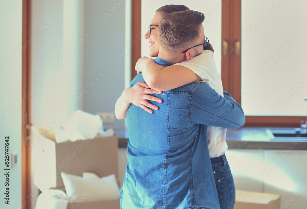 Happy couple hugging in their new house