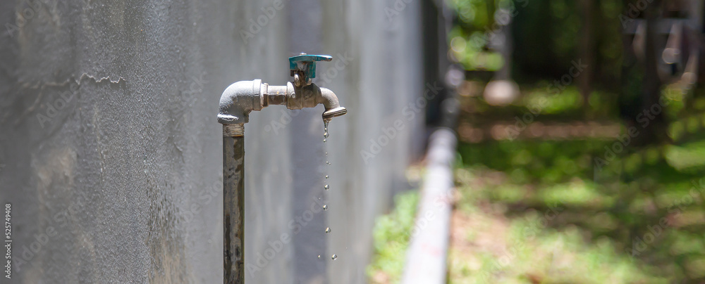 Old faucet outside the house dripping Old faucet outside the house dripping