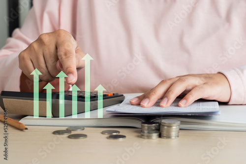Woman doing home accounting calculating book bank statement with business graph icon