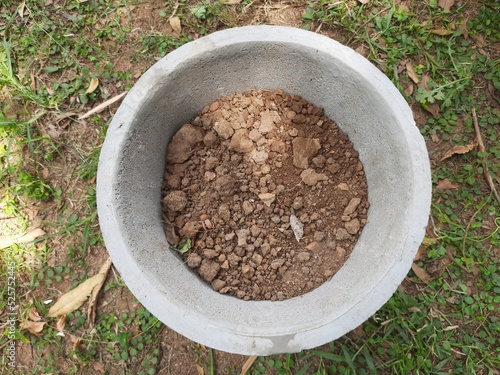 Cement Flowerpot. This pot is ready by filling the soil, now the plant will be planted in it. Gardening work.