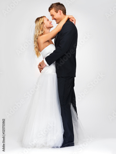 Couple and wedding with a happy bride and groom in studio against a white background. Dress  suit and marriage with a man and woman getting married at a celebration event or ceremony