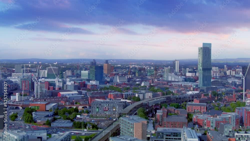 manchester city centre downtown aerial view drone shot at dusk england uk,flying sideways over urban area at sunset manchester city centre downtown aerial view drone shot at dusk england uk,flying sideways over urban area at sunset