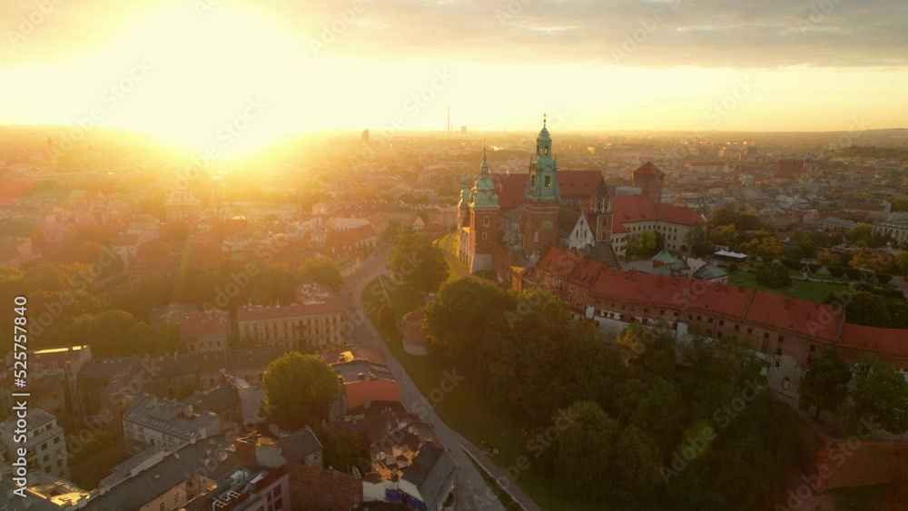 Aerial View at Sunrise of Wawel Royal Castle in Krakow Poland Europe, Orbital Panoramic Scene of the Historical Monument Building Surrounded by Neighborhoods and Cityscape of Cracow Town, Sun Glare