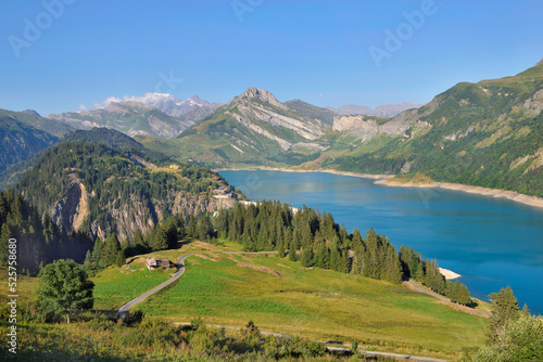 beautiful landscape with a lake and peak montain back and green meadow in the foreground in french Alps