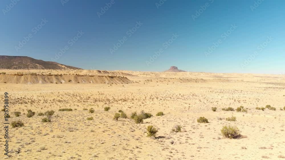 Top angle aerial view desert New Mexico Drone shot of western sand dunes and mountains with blue clear cloudless sky and brush steppe 4K UHD 3840