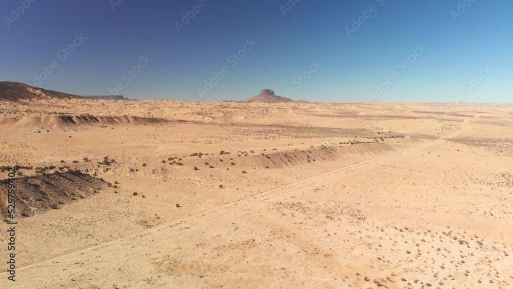 Top angle aerial view desert New Mexico Drone shot of western sand dunes and mountains with blue clear cloudless sky and brush steppe 4K UHD 3840 Top angle aerial view desert New Mexico Drone shot of western sand dunes and mountains with blue clear cloudless sky and brush steppe 4K UHD 3840