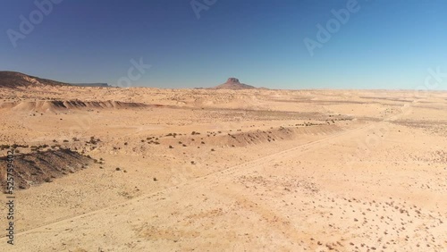 Top angle aerial view desert New Mexico Drone shot of western sand dunes and mountains with blue clear cloudless sky and brush steppe 4K UHD 3840