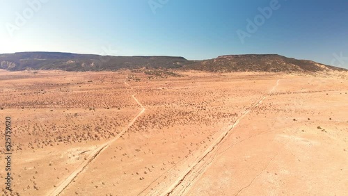 Top angle aerial view desert New Mexico Drone shot of western sand dunes and mountains with blue clear cloudless sky and brush steppe 4K UHD 3840