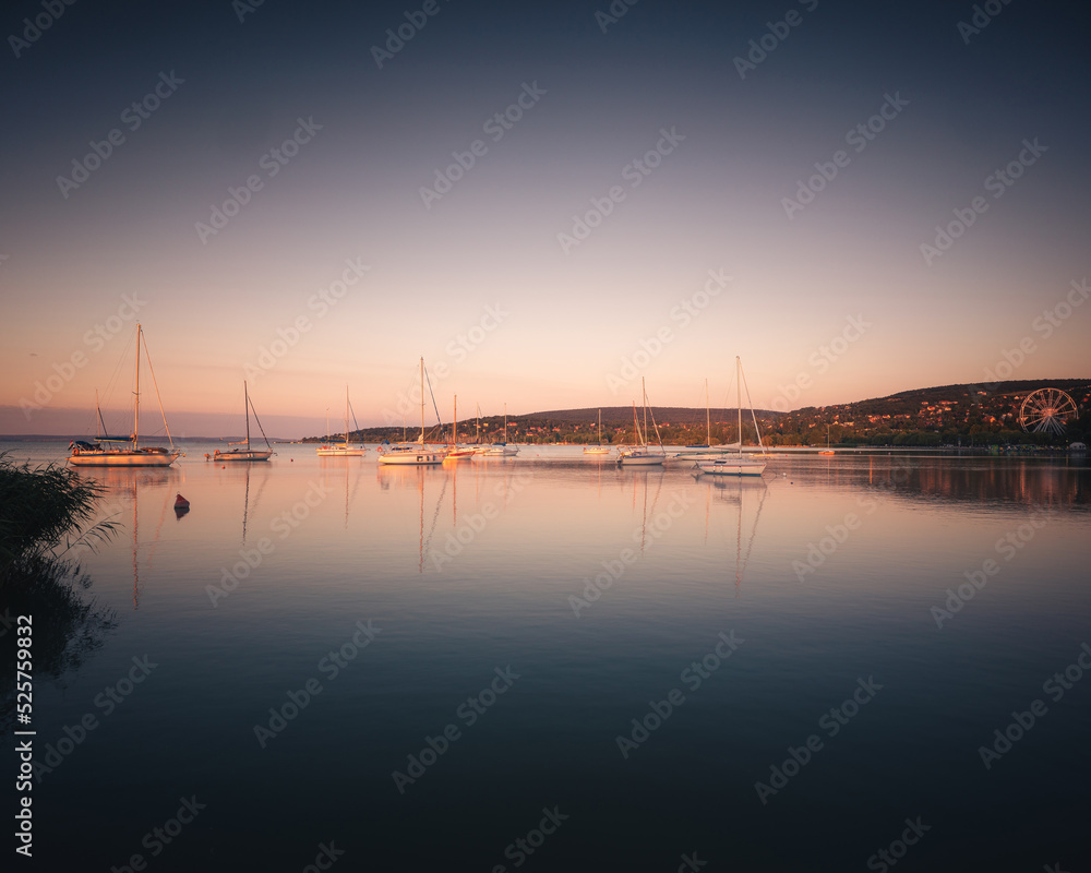 Relaxing morning at lake Balaton with sailboats in the summer