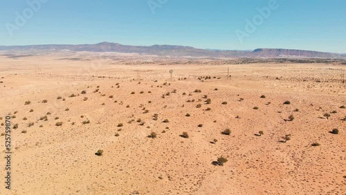 Top angle aerial view desert New Mexico Drone shot of western sand dunes and mountains with blue clear cloudless sky and brush steppe 4K UHD 3840