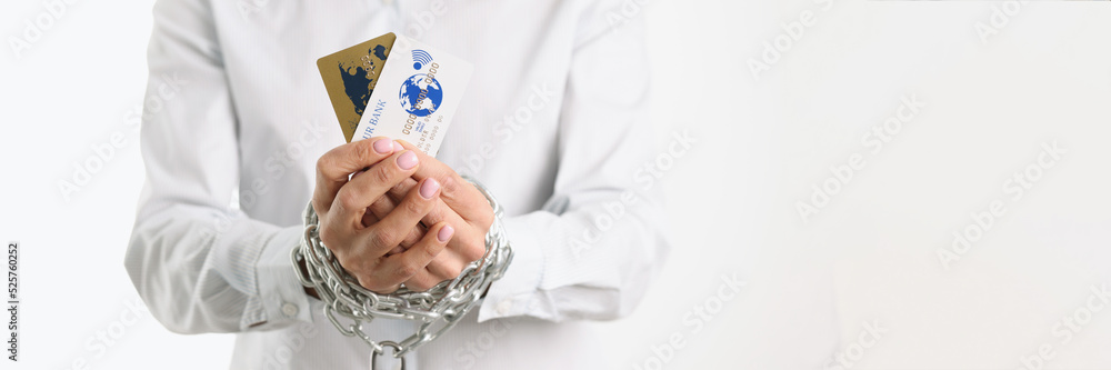 Bank cards in hand and chain on lock closeup