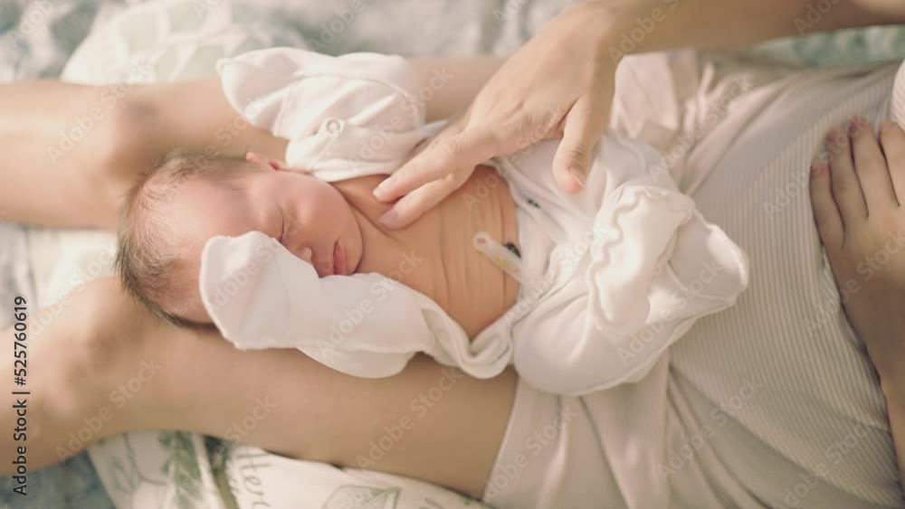 top view newborn baby lies on mother's lap top view newborn baby lies on mother's lap