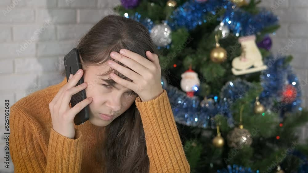 Girl upset call for new Year. An upset young girl speak with somebody on her telephone during Christmas time. Girl upset call for new Year. An upset young girl speak with somebody on her telephone during Christmas time.