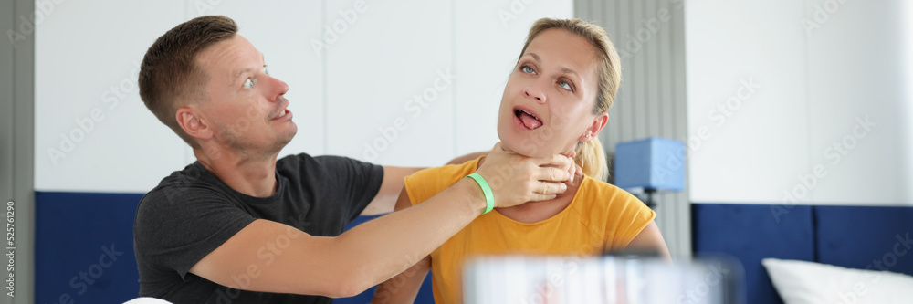 Man jokingly strangles young woman on camera Man jokingly strangles young woman on camera