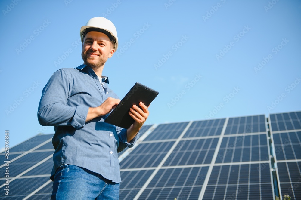 Young architect standing by solar panels Young architect standing by solar panels