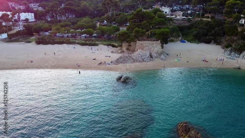 sunset luxury campsite directly on the sea, turquoise water
Daring aerial view flight tilt up drone footage at golden houre evening in spain aro beach summer 2022. Marnitz 4k Cinematic view from above photo