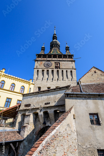 The The Clock Tower or the Council Tower of the medieval citadel in the old center of Sighisoara, a UNESCO World Heritage Site in Transylvania (Transilvania) region, Romania, in a sunny summer day.