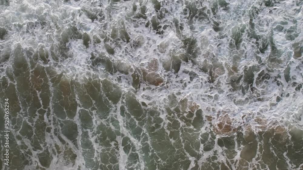 Top down view of breaking waves, whitewash. Huge swell hitting shoreline. Top down view of breaking waves, whitewash. Huge swell hitting shoreline.