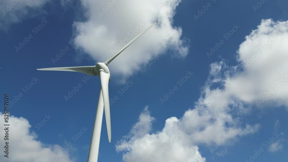 Tracking Shot With Pan Up Of Wind Turbines Spinning On A Sunny Day Tracking Shot With Pan Up Of Wind Turbines Spinning On A Sunny Day