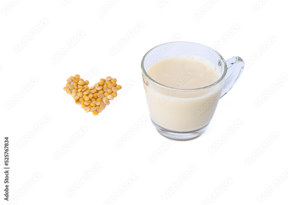 Soy milk is made from grinding soybeans. and bring to a boil to add sweetness with sugar healthy drink Soy milk in a glass on a white background. Soy milk is made from grinding soybeans. and bring to a boil to add sweetness with sugar healthy drink Soy milk in a glass on a white background.