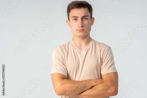 Young guy in a light T-shirt on a white background