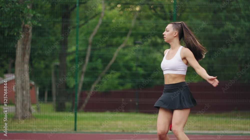 attractive young brunette woman is playing tennis on open court in summer day, serving ball attractive young brunette woman is playing tennis on open court in summer day, serving ball