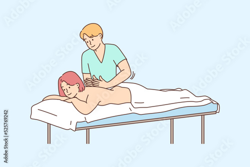 Therapist doing massage to female client 