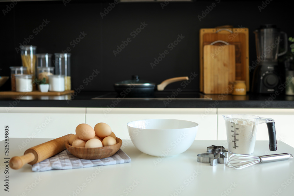 Baking ingredients placed on wooden table, ready for cooking. Copyspace for text. Concept of food preparation, kitchen on background Baking ingredients placed on wooden table, ready for cooking. Copyspace for text. Concept of food preparation, kitchen on background