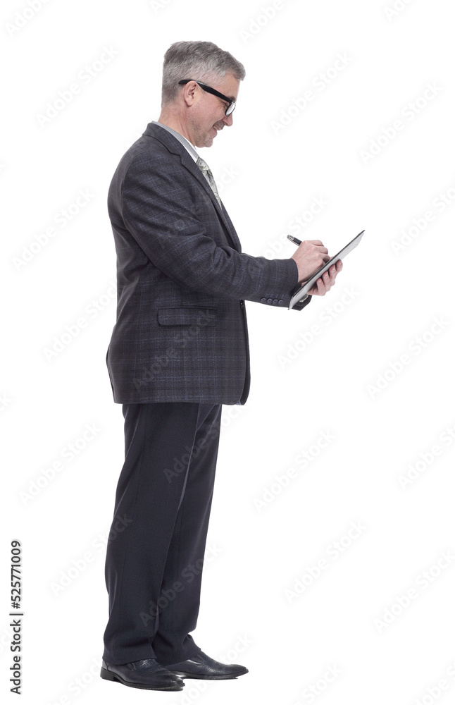 in full growth. business man making an entry in the clipboard. in full growth. business man making an entry in the clipboard.