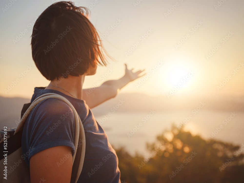 Fototapeta premium Travel to Turkey, viewpoint over Dalyan Iztuzu Beach. . Smiling woman taking break on hiking trip looking at view at sunset. Explore natural wonders of Turkey