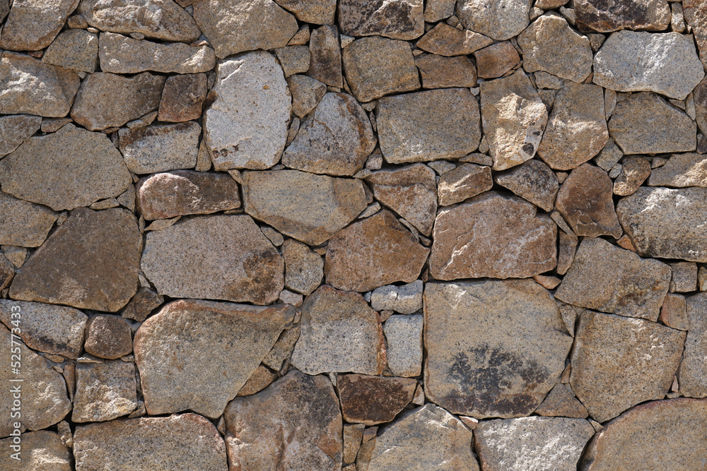 Fototapeta premium masonry without cement. Beige stone in the wall without cement. Ancient masonry without cement. Classical walls, fences in sardinia in italy.