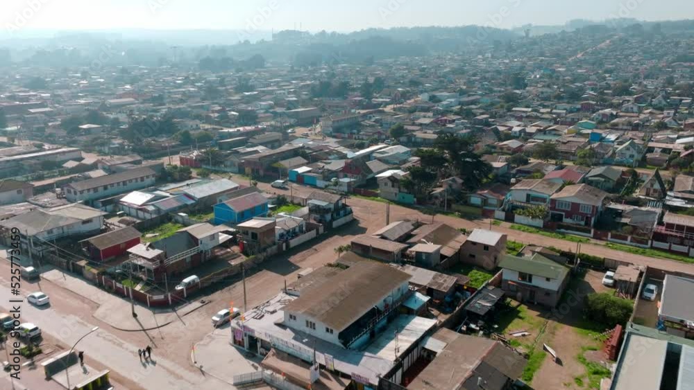 Aerial dolly in of low residential houses in Cartagena seaside neighborhood near sand beach, mounts in background, Valparaiso, Chile Aerial dolly in of low residential houses in Cartagena seaside neighborhood near sand beach, mounts in background, Valparaiso, Chile