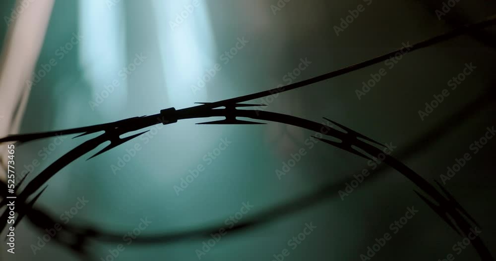 Abstract Time-Lapse of Freeway Traffic with Barbed Wire in the Foreground. Abstract Time-Lapse of Freeway Traffic with Barbed Wire in the Foreground.
