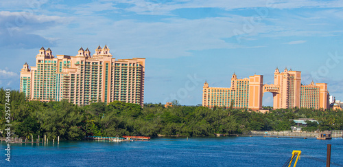 Panoramic view of Atlantis buildings in Nassau, The Bahamas, with blue skies near a coastline | Replica of Atlantis buildings in Nassau, Bahamas Image Background 