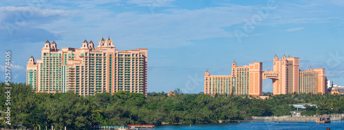 Panoramic view of Atlantis buildings in Nassau, The Bahamas, with blue skies near a coastline | Replica of Atlantis buildings in Nassau, Bahamas Image Background 
