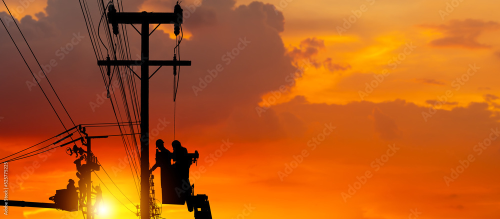 Silhouette of Electrician officer climbs a pole and uses a cable car to maintain a high voltage line system, Shadow of Electrician lineman repairman worker at climbing work on electric post power pole - obrazy, fototapety, plakaty 