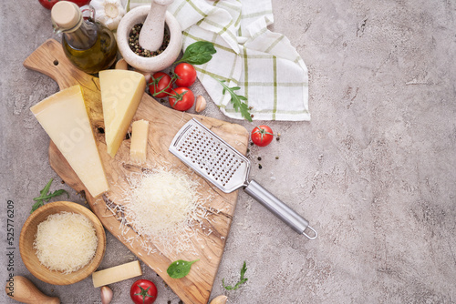 Cuadro en lienzo Parmesan cheese and grater on a wooden cutting board