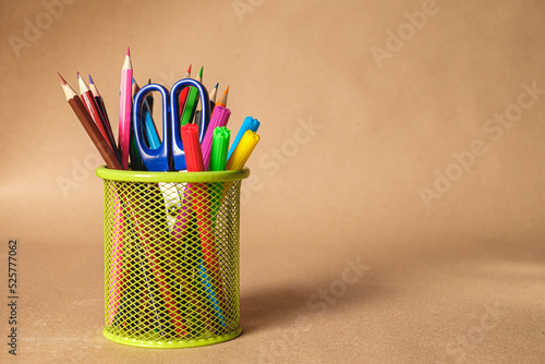 Set of colorful school stationery on brown background.  With space for text 