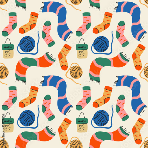 Cozy seamless pattern with autumn items from a ball of thread, a scarf, socks. For autumn decor, fall holidays invitations, fabric, kitchen textiles and cover, gift and wrapping paper.