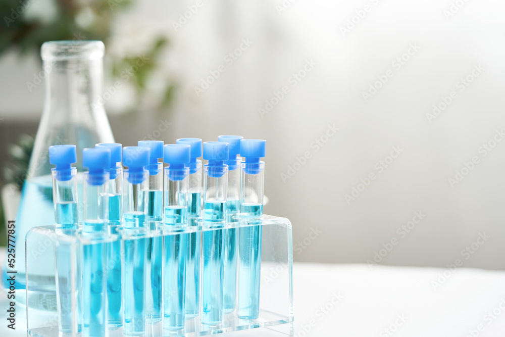 concept of science biology test tube with blue liquid on white background                                                             
