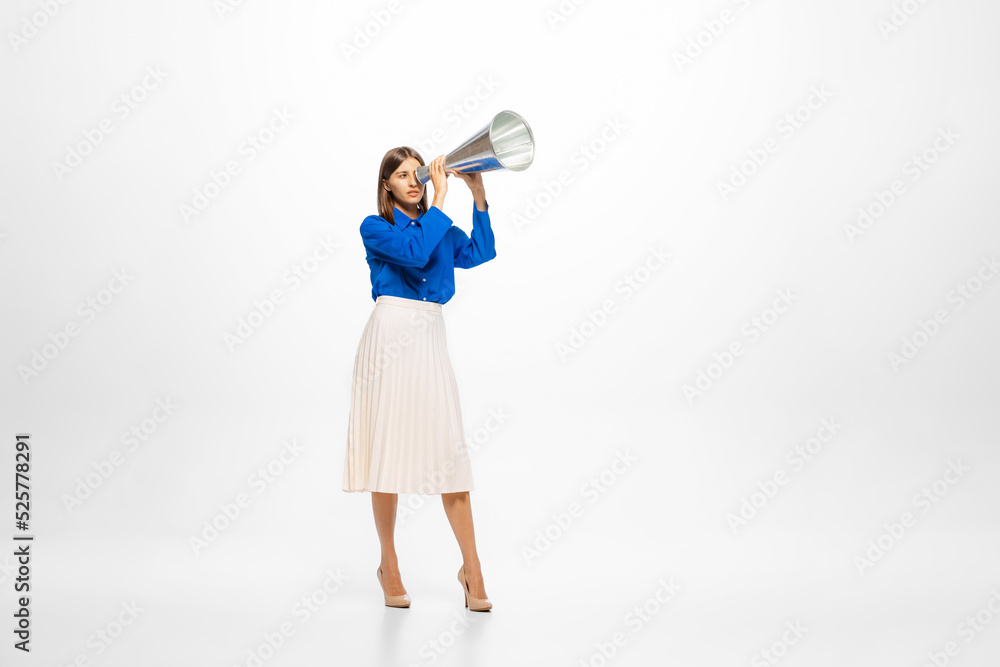 Portrait of young man looking in tube isolated over white background. Professional predictions, new perspectives