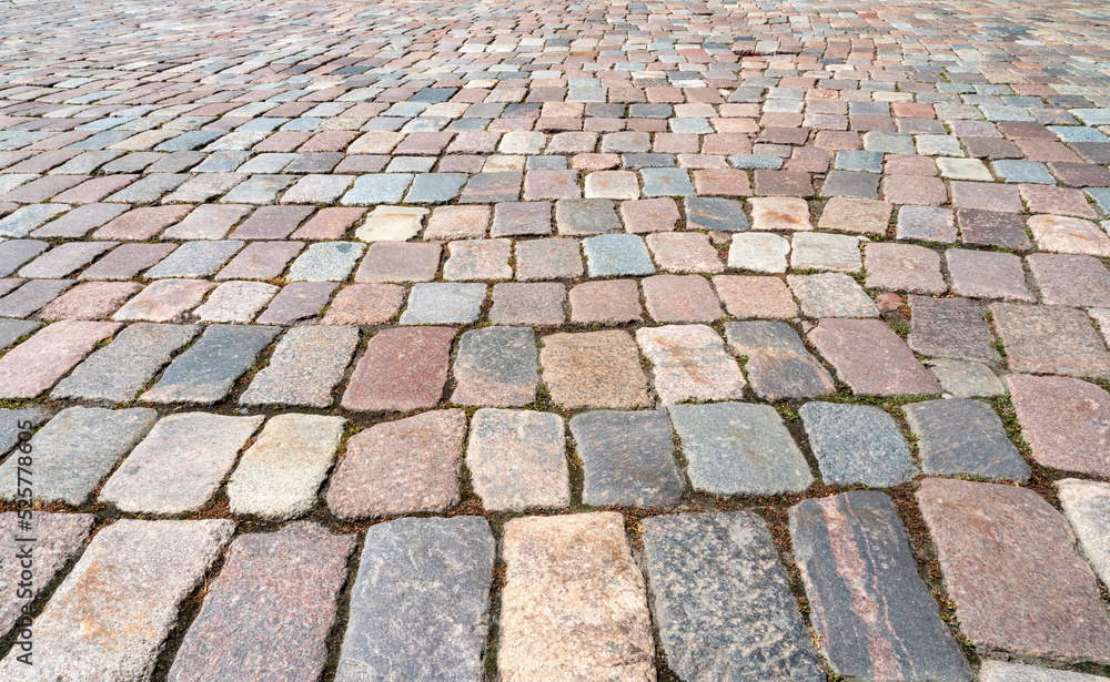 Natural old cobblestone sidewalk or pavement, top view, as texture or background