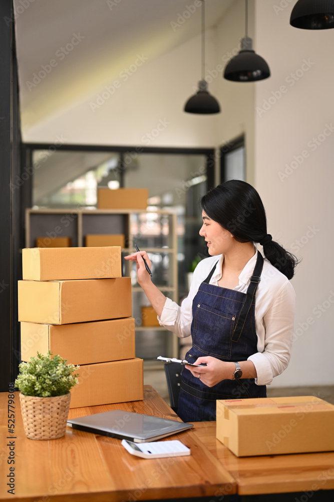 Small business entrepreneur preparing parcel boxes of product for delivery to costumer. Online selling, e-commerce concept Small business entrepreneur preparing parcel boxes of product for delivery to costumer. Online selling, e-commerce concept